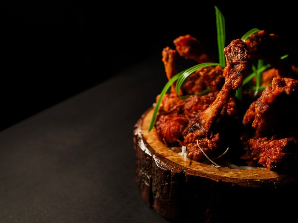 Assortment of soul-food proteins including oxtails, salmon, and chicken wings